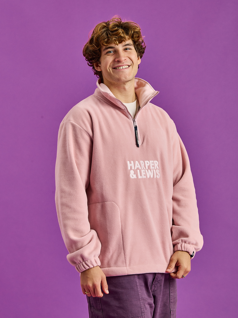 Male Model wearings the Dusty Pink Fleece Jacket, showcasing the tonal embroidered 'Harper & Lewis' Logo.