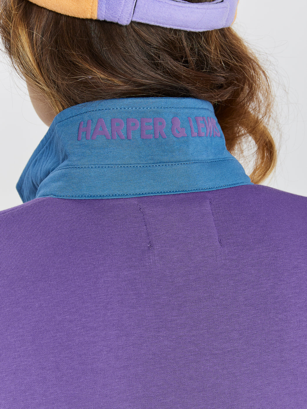 Details of the petrol collar with the purple printed text under. 