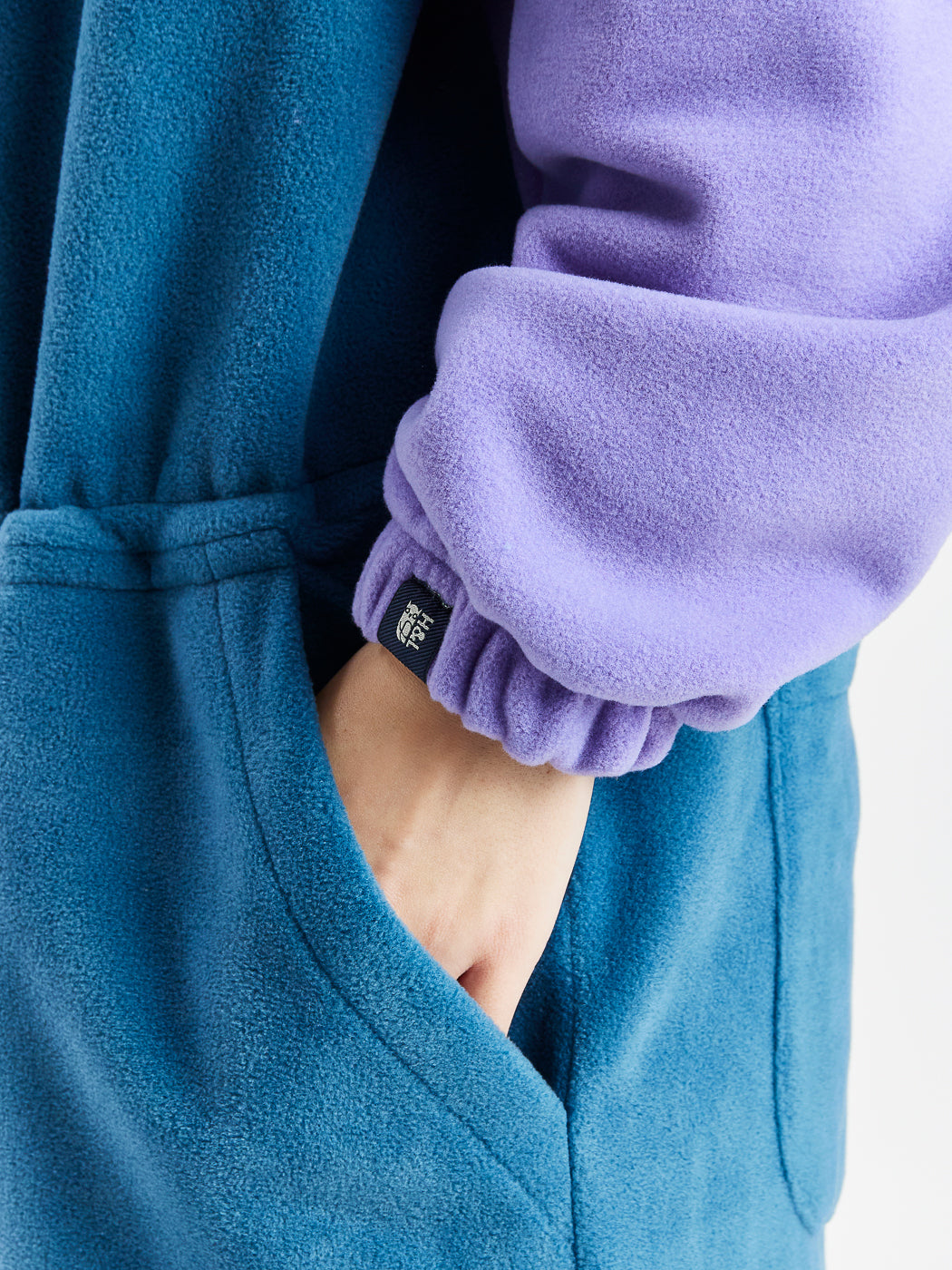 Harper & Lewis branded woven tab on the lavender fleece cuff.