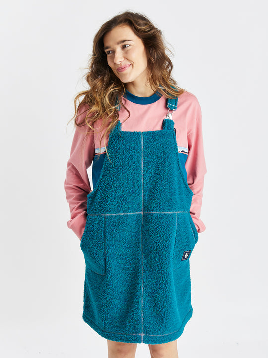 Harper and Lewis Syd Sherpa dress pinafore in teal green with pink contrast stitching.