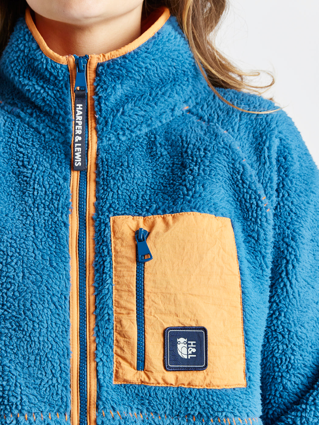 Sherpa fleece featuring a branded zip puller on the full zip fleece.