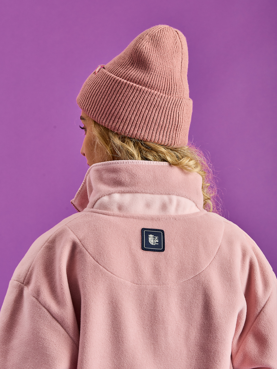 Unisex fleece jacket showcasing the Light Pink design on the back collar.