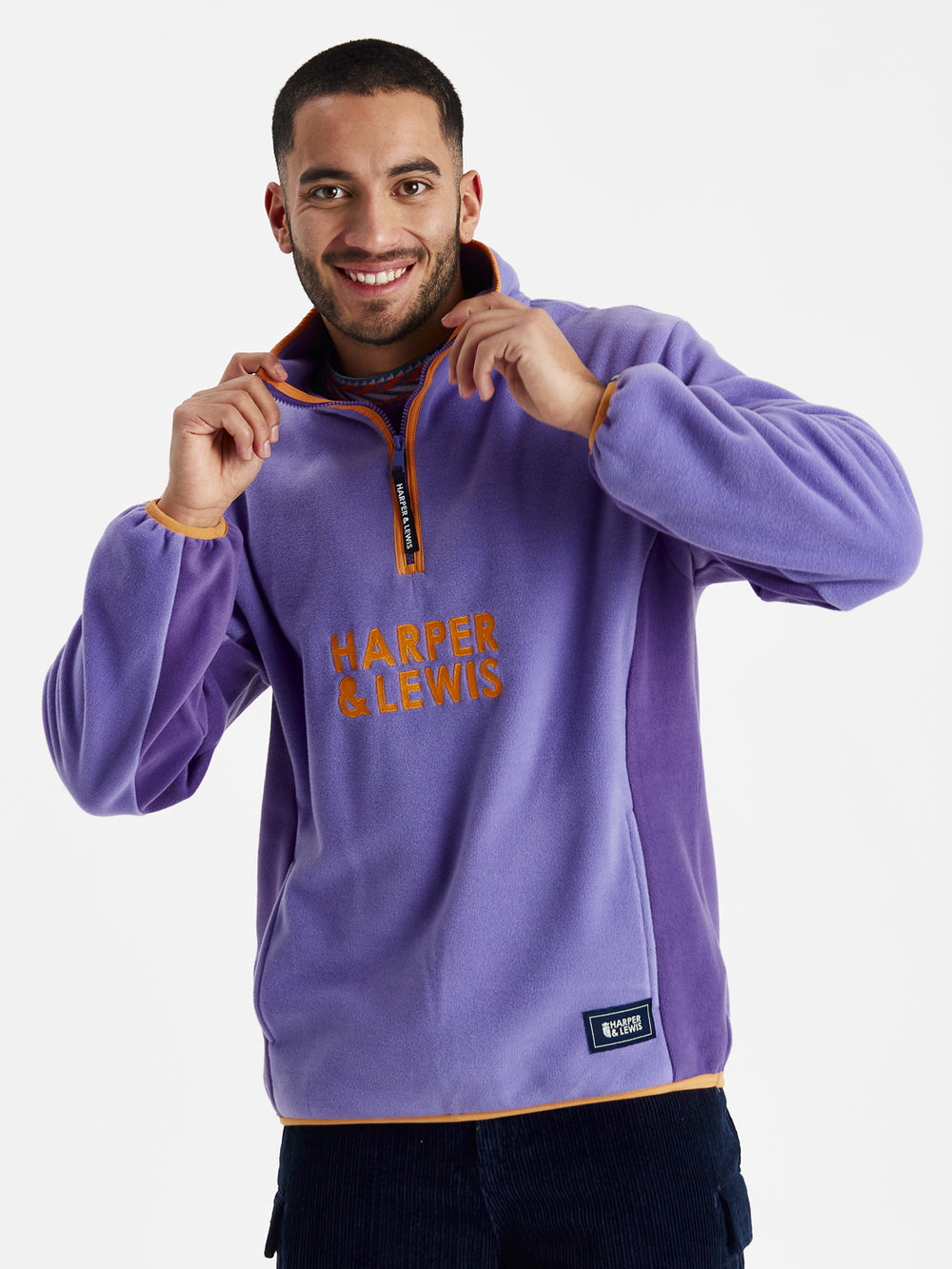 unisex Fleece in Deep Lavender and Deep Purple with a quarter-zip collar, relaxed fit, and embroidered logo on chest.