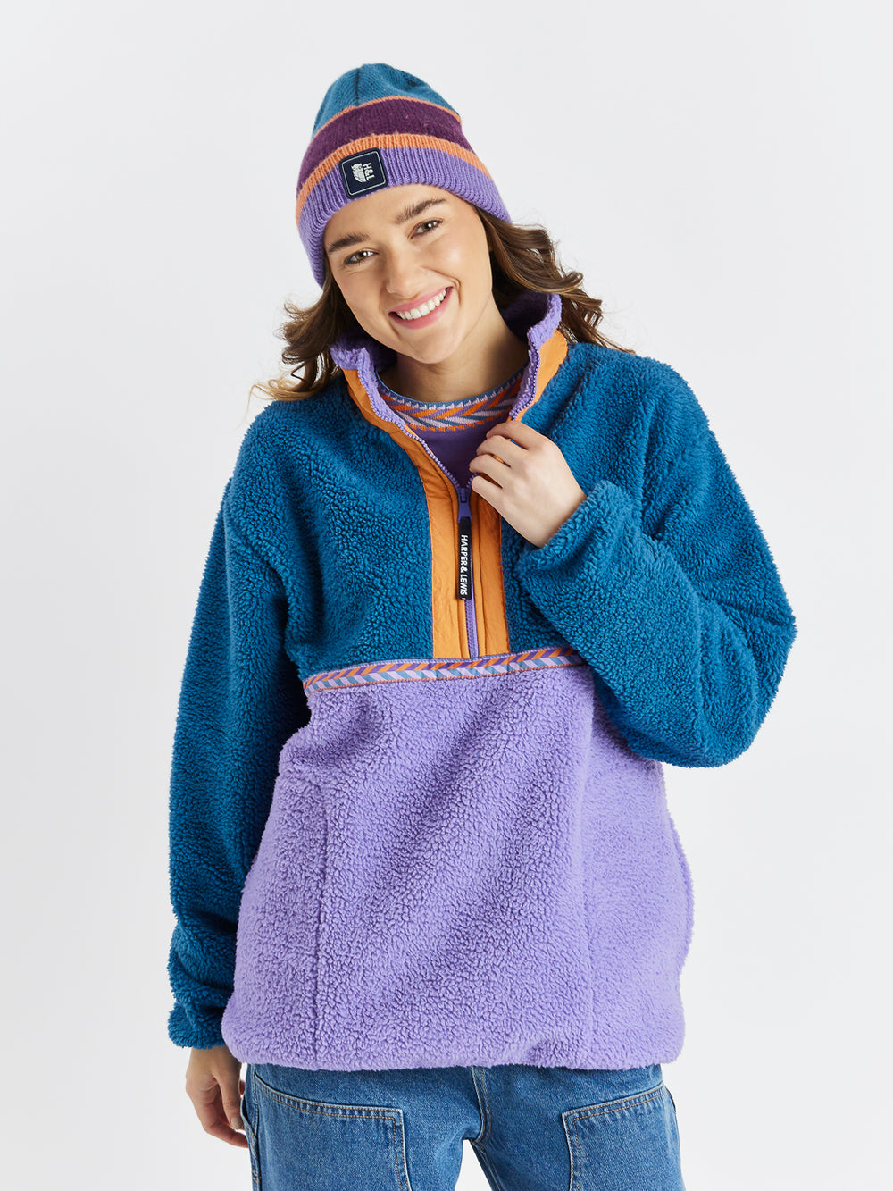 Featuring a vibrant mix of Deep Lavender, Deep Purple, Apricot and Petrol, this beanie combines warmth and style.