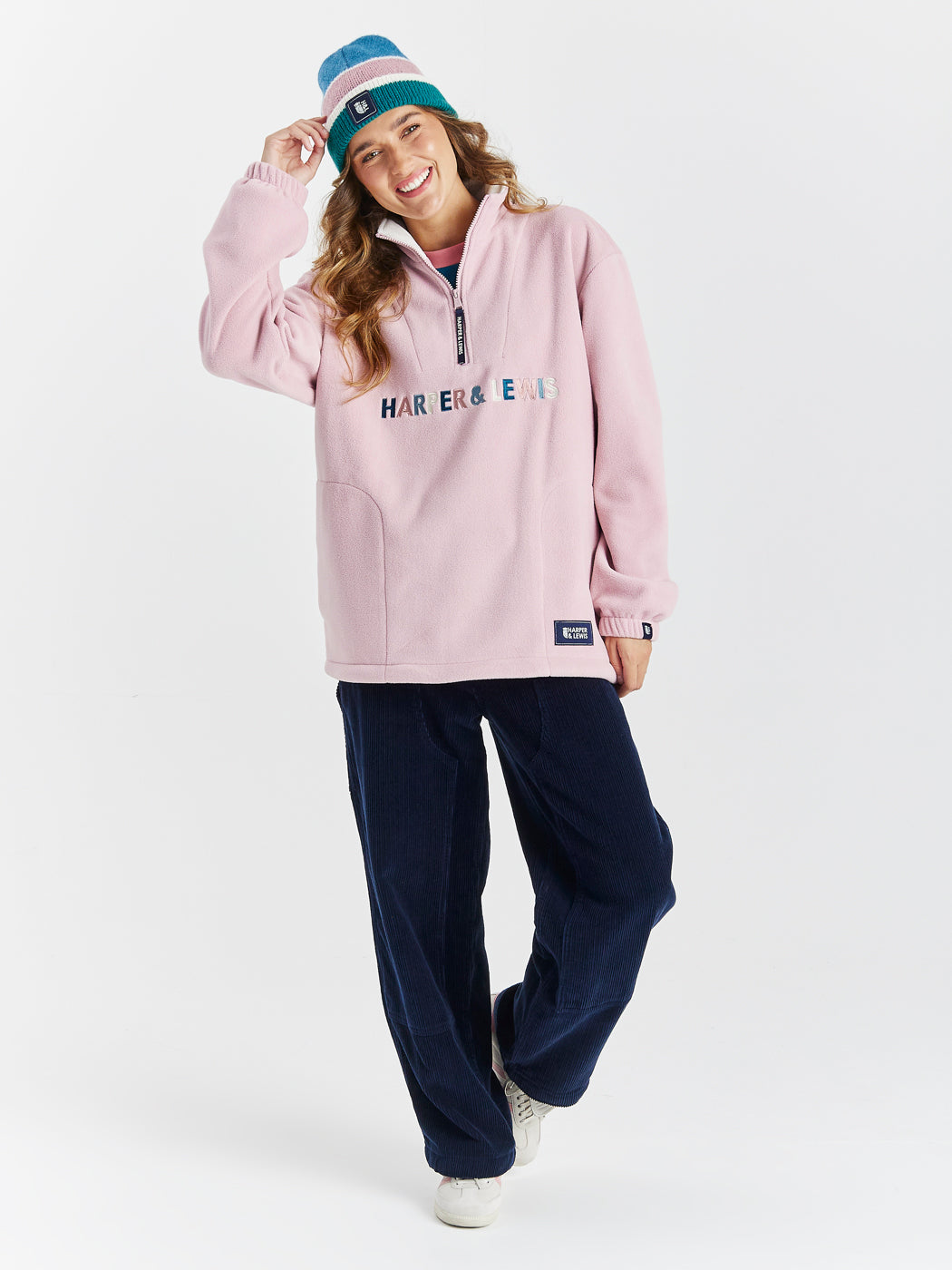 Eirwen unisex Fleece in Dusty Pink with a quarter-zip collar, relaxed fit, and embroidered logo on chest.