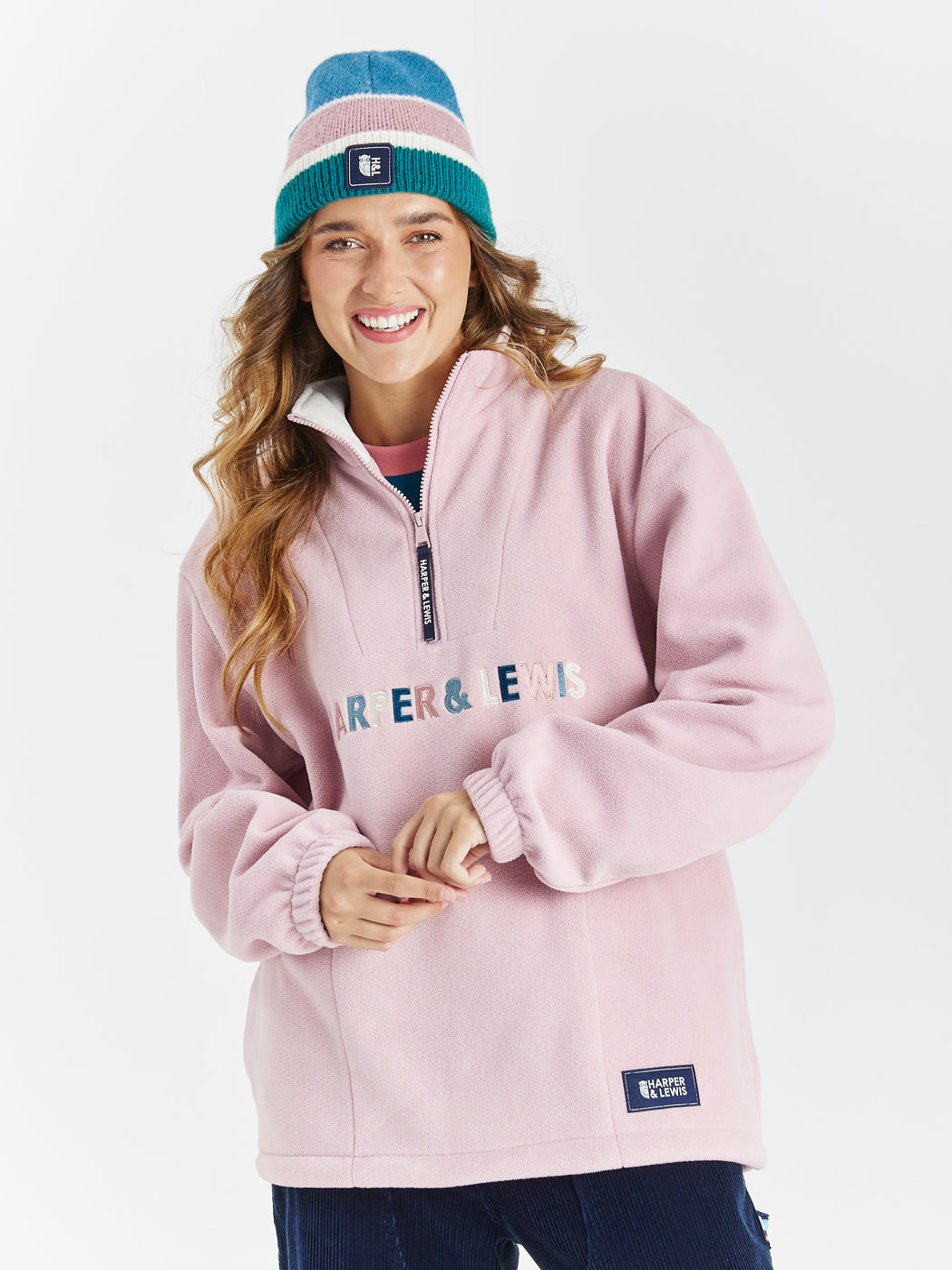 Colours to match the season in the embroidery, featuring cream, sage, dusty pink and petrol, to make up a colourful spellout, on this Quarter Zip Fleece.