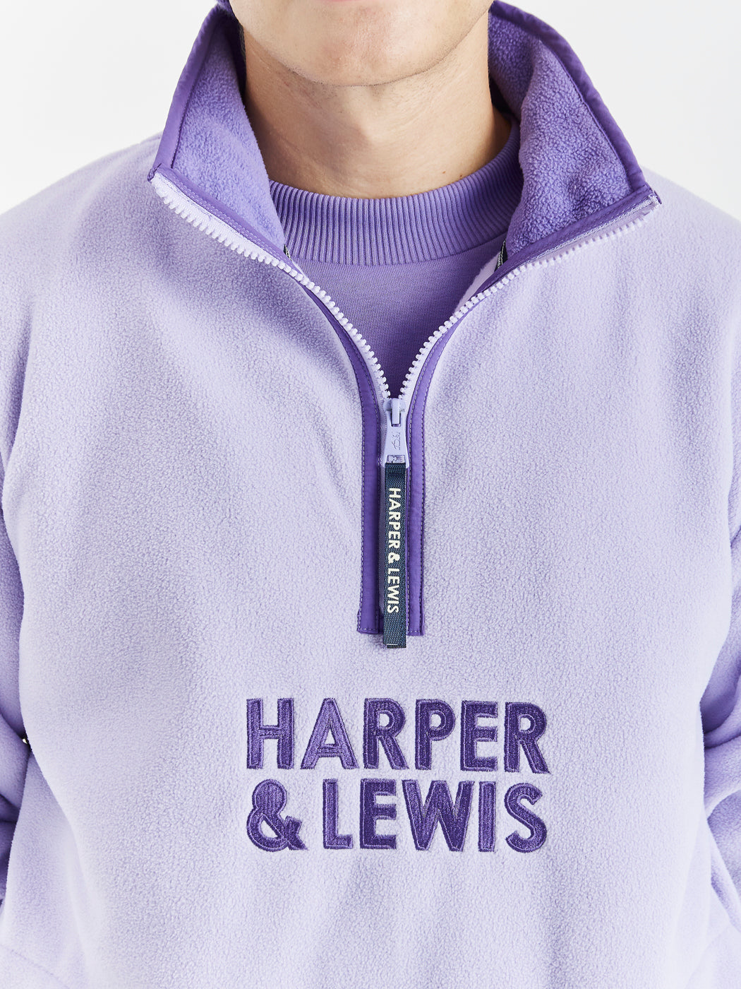 Comfort-fit Harper & Lewis Polar Fleece, with a relaxed silhouette, 1/4 zip collar, and soft fleece texture. Embroidered chest logo adds a refined touch.