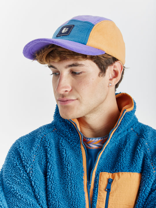 Featuring a colour block patchwork with colours including Petrol, Lavender and Apricot on the Fleece hat.