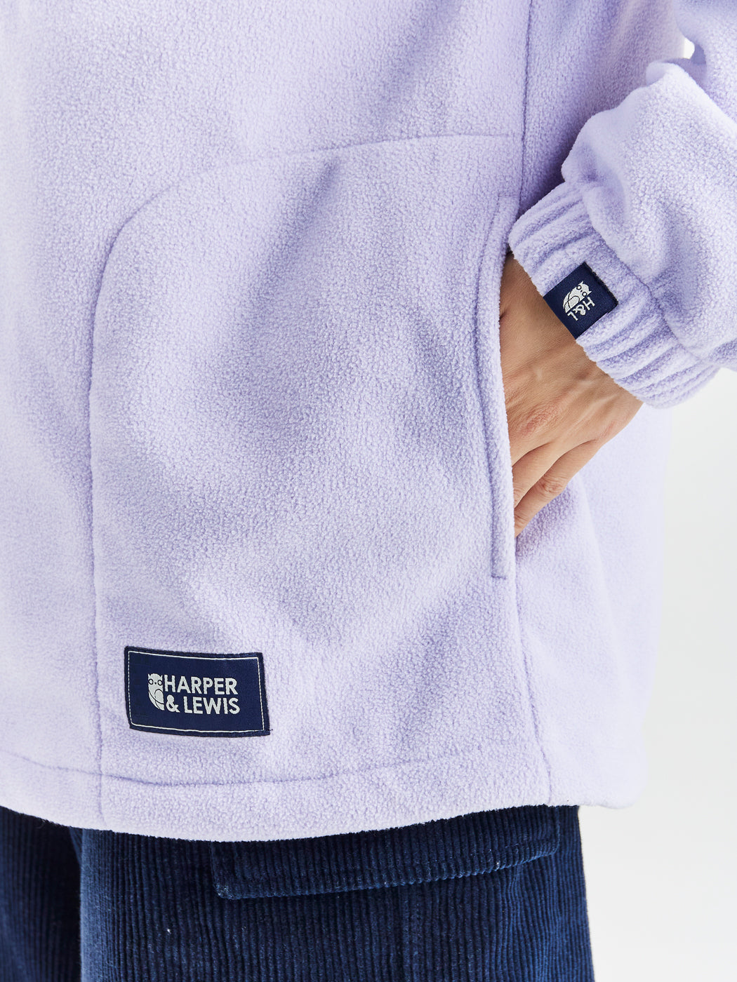 Navy detailing consists of, branded tabs on the pocket and sleeves, a woven badge on the back of the neck and a Branded zip puller on this cosy fleece.