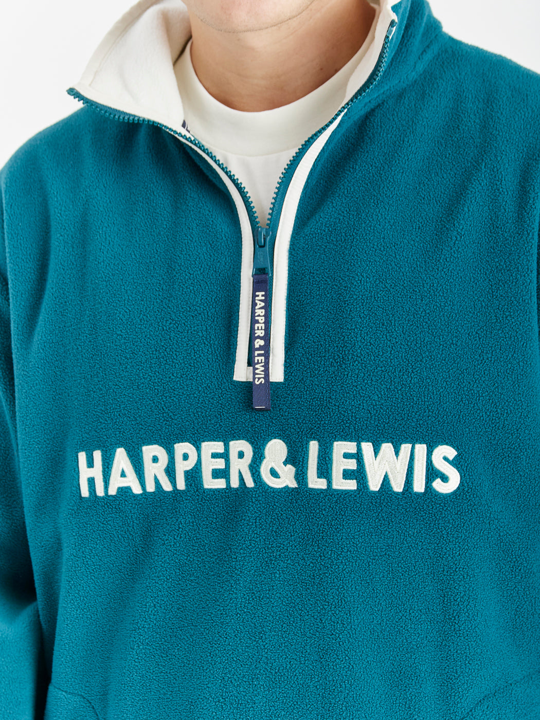 Navy detailing consists of, branded tabs on the pocket and sleeves, a woven badge on the back of the neck and a Branded zip puller on this cosy fleece.
