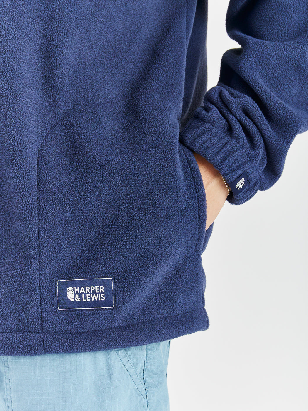 Navy detailing consists of, branded tabs on the pocket and sleeves, a woven badge on the back of the neck and a Branded zip puller on this cosy fleece.
