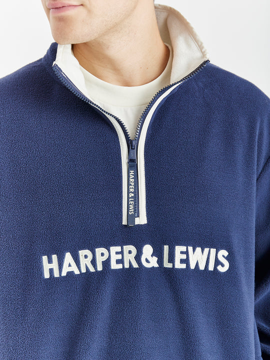 Comfort-fit Harper & Lewis Polar Fleece, with a relaxed silhouette, 1/4 zip collar, and soft fleece texture. Embroidered chest logo adds a refined touch.
