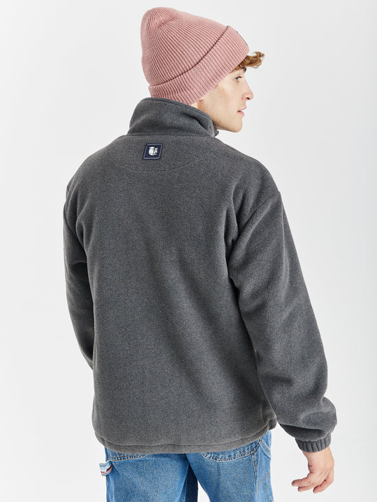 Navy detailing consists of, branded tabs on the pocket and sleeves, a woven badge on the back of the neck and a Branded zip puller on this cosy fleece.
