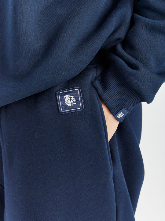 Branded Harper & Lewis badge in navy, on the waistband by the side entry pockets.