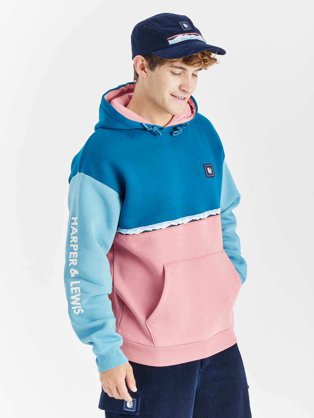 The Georgie Hooded Sweatshirt features a captivating retro pattern detail across the chest