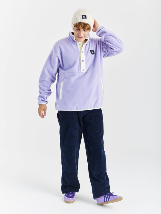 unisex Fleece in Lavender with a Popper Neck Closure, relaxed fit, and Branded badge on chest.
