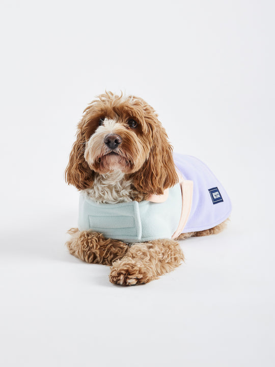 The branded badge at the collar adds a touch of style to this patterned dogs coat.