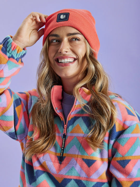 Brighten up your winter wardrobe with the Vail Beanie in Coral.
