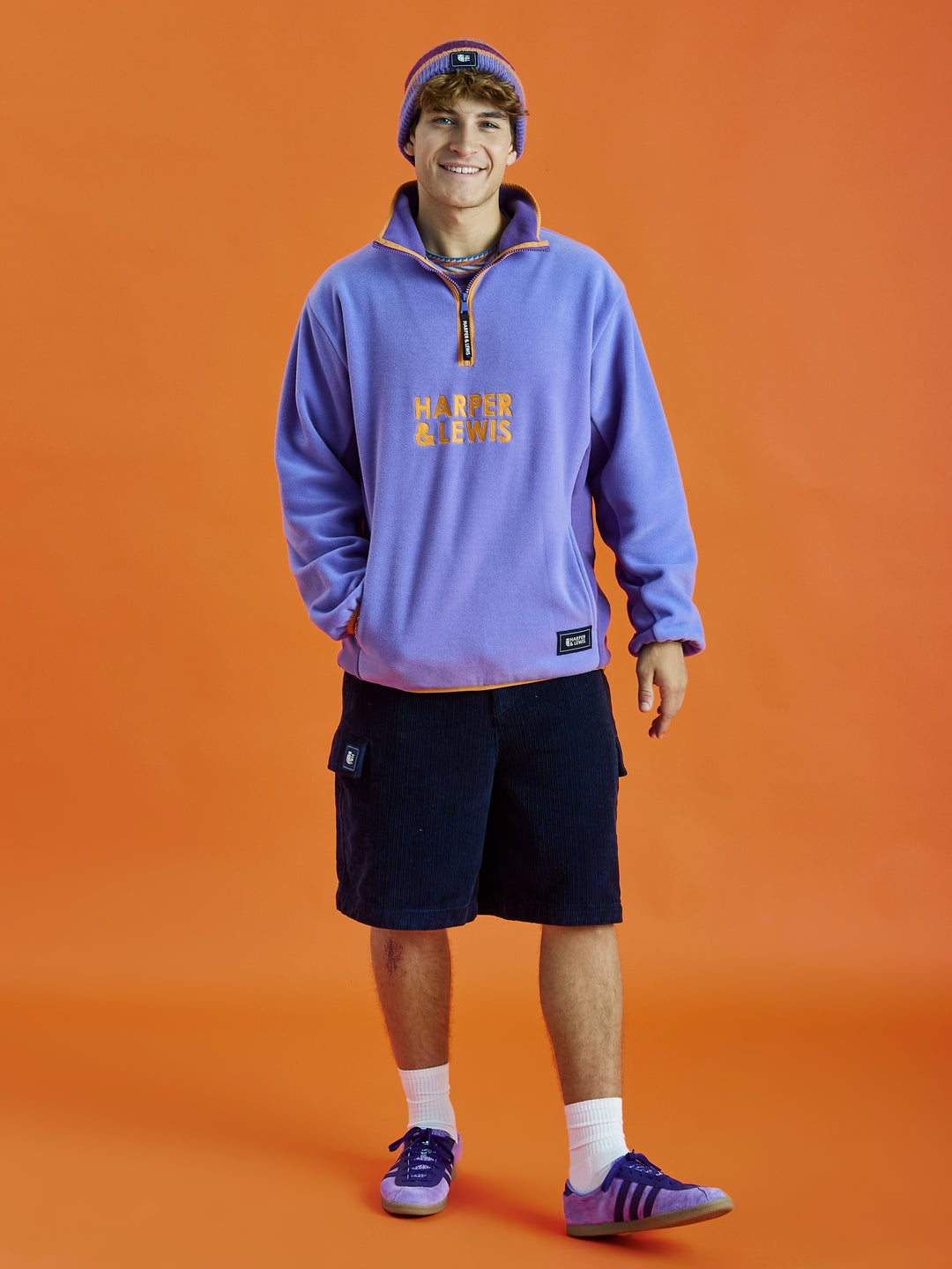 Inspired by a vintage fleece, this Deep Lavender colour block fleece, with orange details is a must-have item for your wardrobe. 