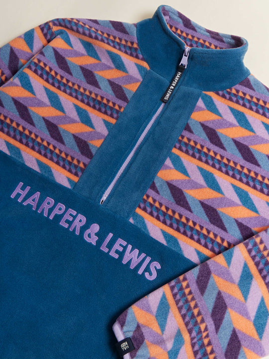 Unisex patterned fleece with purple embroidered branding and a branded tab on the sleeve.