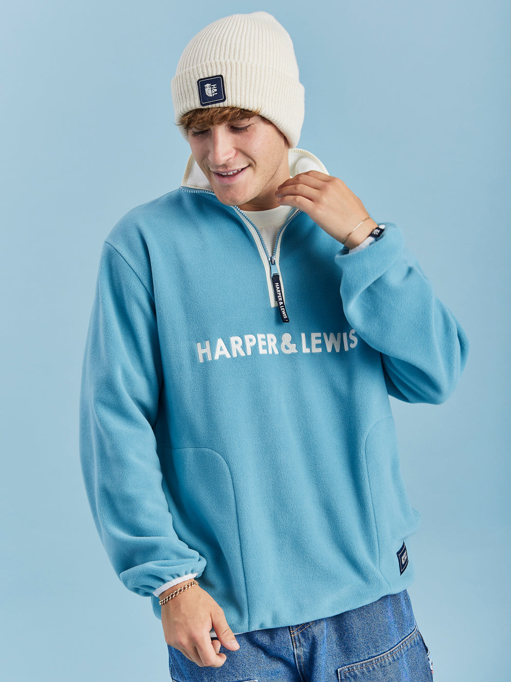 unisex Fleece in Steel Blue with a quarter-zip collar, relaxed fit, and embroidered logo on chest.
