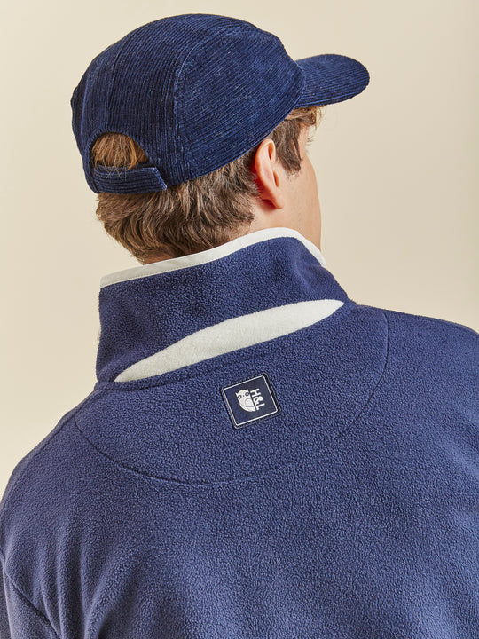 unisex Fleece in Navy with a quarter-zip collar, relaxed fit, and embroidered logo on chest.
