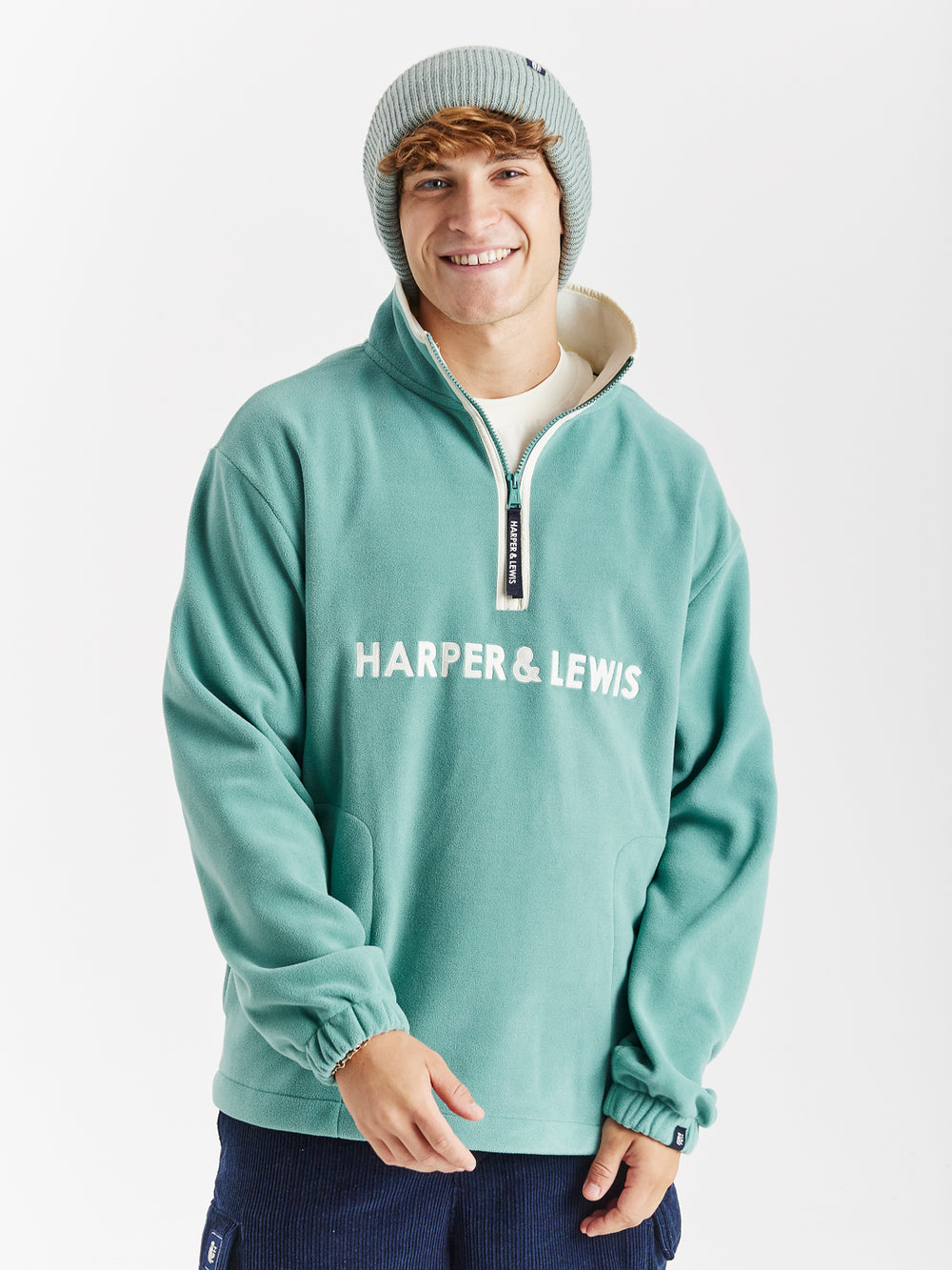 unisex Fleece in Sage with a quarter-zip collar, relaxed fit, and embroidered logo on chest.