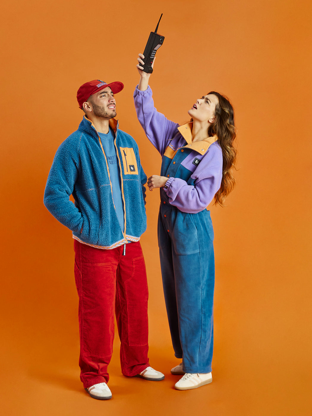 This fleece boilersuit features a bold colour-block design with a Petrol lower half and a Deep Lavender top half.