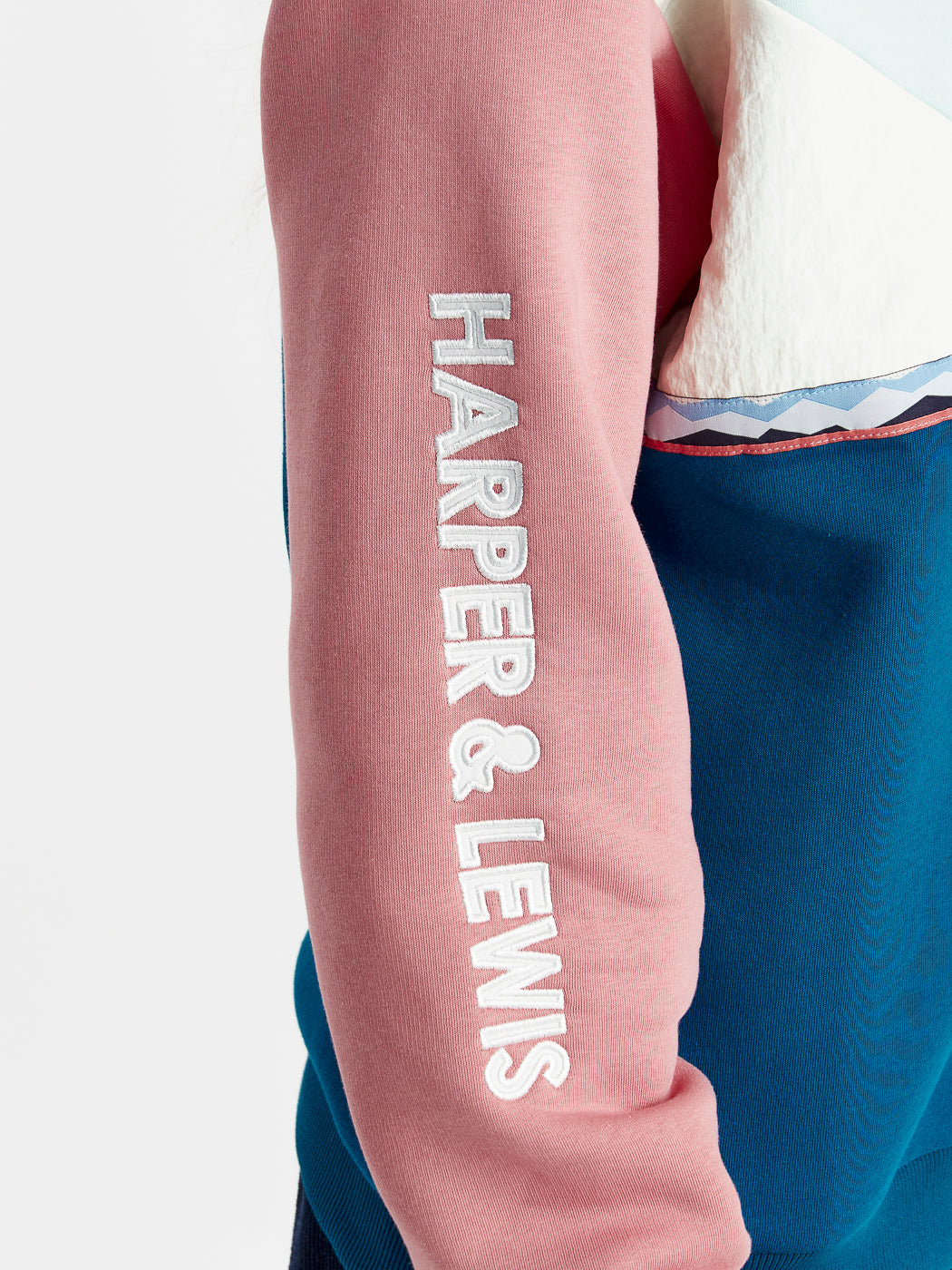 The Releigh quarter zip sweater features a Harper & Lewis embroidery across the arm in cream.
