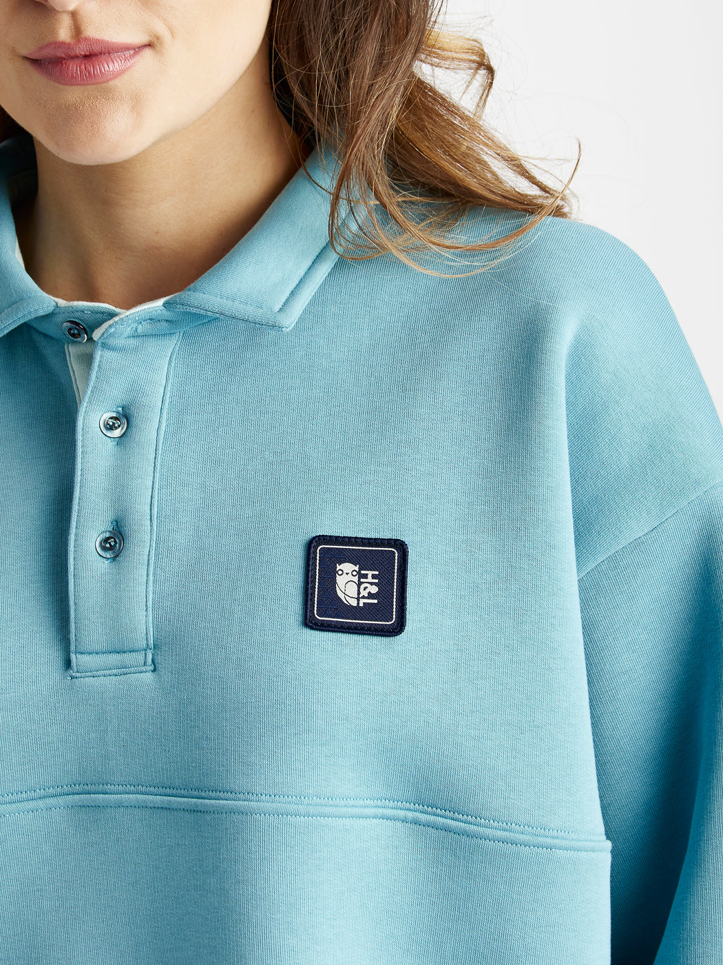 Branded Harper & Lewis navy badge on the chest of this Steel Blue rugby shirt.