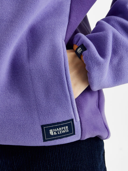 Navy detailing consists of, branded tabs on the pocket and sleeves, a woven badge on the back of the neck and a Branded zip puller on this cosy fleece.