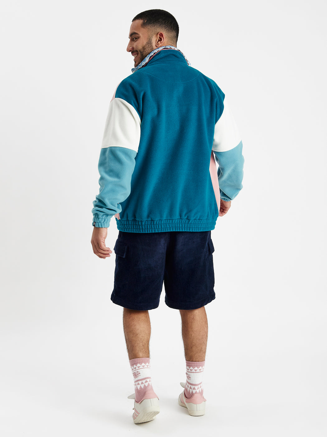 Cosy fleece featuring Teal green back with colour block arm details.