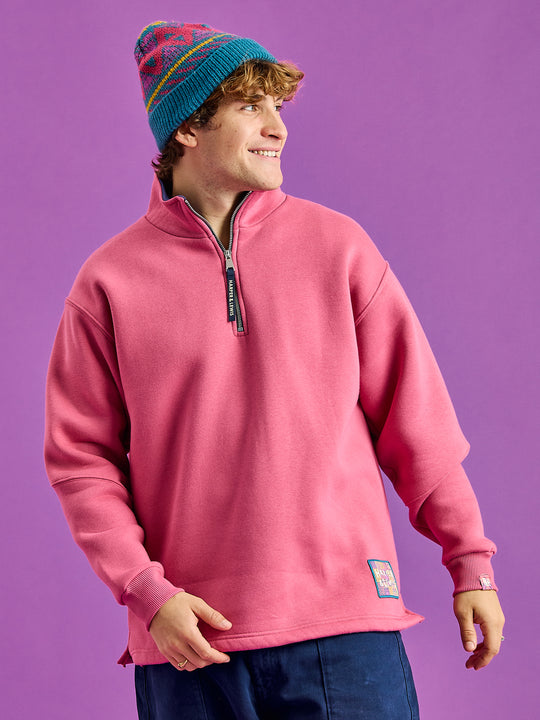 Male Model wears the quarter zip sweat with a woven branded badge at hem, and tab at cuff and back neck.