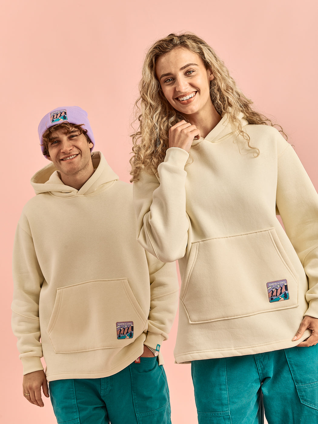 Both Models wearing the unisex hoodie, with subtle detailing