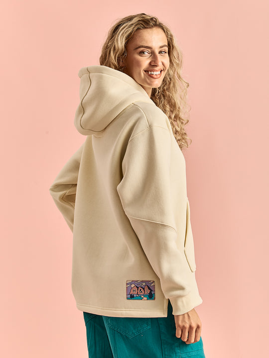 Female Model wearing the unisex hoodie, showing the arm details and the back badge