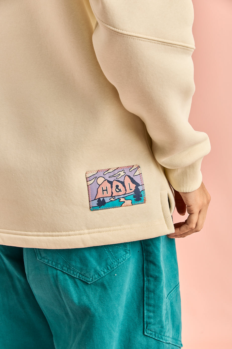 Detail shot of the banded mountain inspired badge on the back of the hoodie