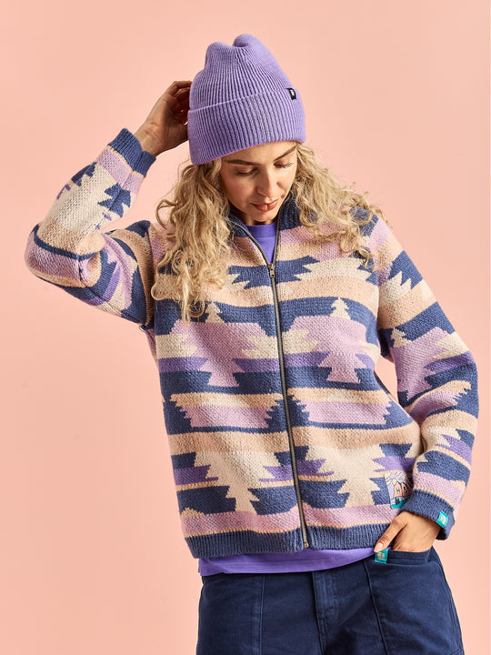 Female model wears the Wynn Retro Unisex Cardigan which is made from, 75% Acrylic, 25% Nylon.