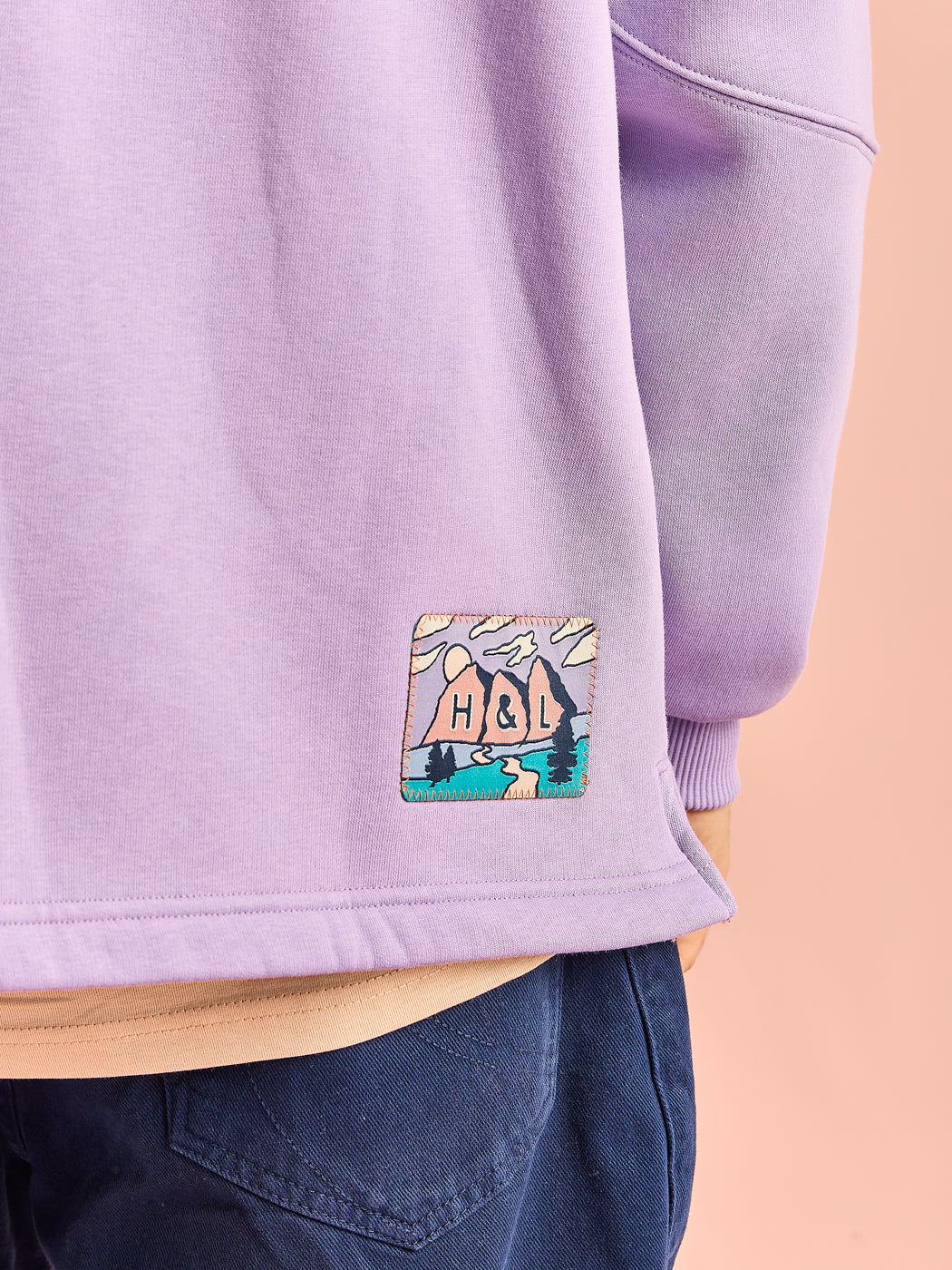 Detail of the woven retro inspired mountain patch on the back hem
