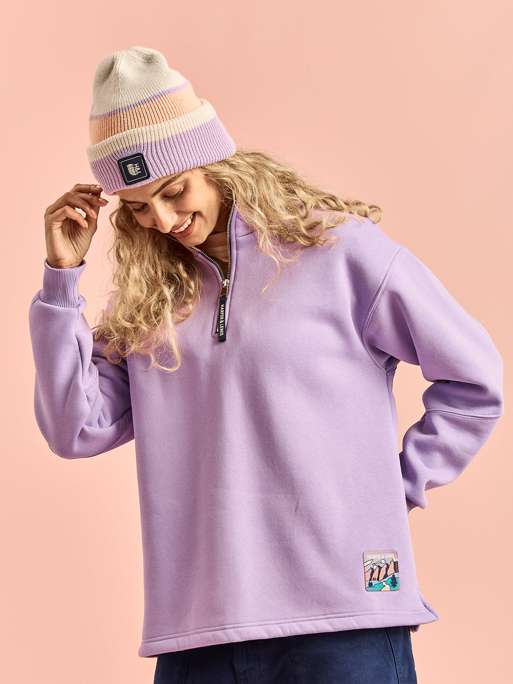This quarter zip is made from a brush back fleece material, the sweater is composed of 65% cotton and 35% polyester, ensuring durability and warmth.