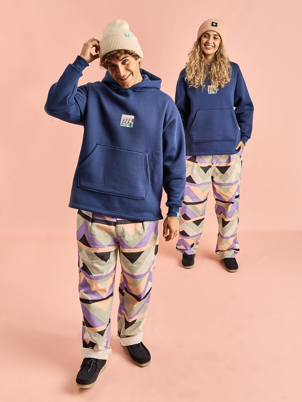 Both models wearing the Ezra patterned trousers made from 100% Cotton Twill