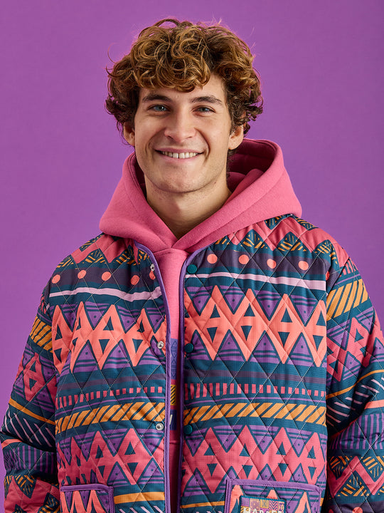 The Zinnia Unisex Quilted Jacket with the Aztec Wave pattern shows hues of Teal, Dark Rose, Deep Mulberry, Orchid, Deep Peach & Mustard.