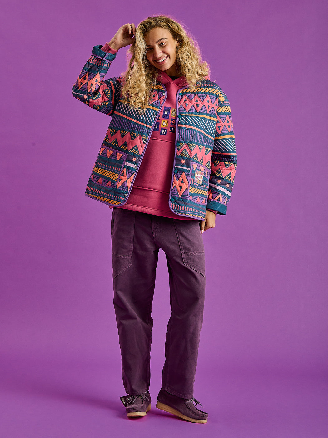 Female Model wearing the unisex quilted jacket perfectly layered with the Garnet Hoodie.
