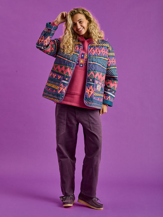 Female Model wearing the unisex quilted jacket perfectly layered with the Garnet Hoodie.
