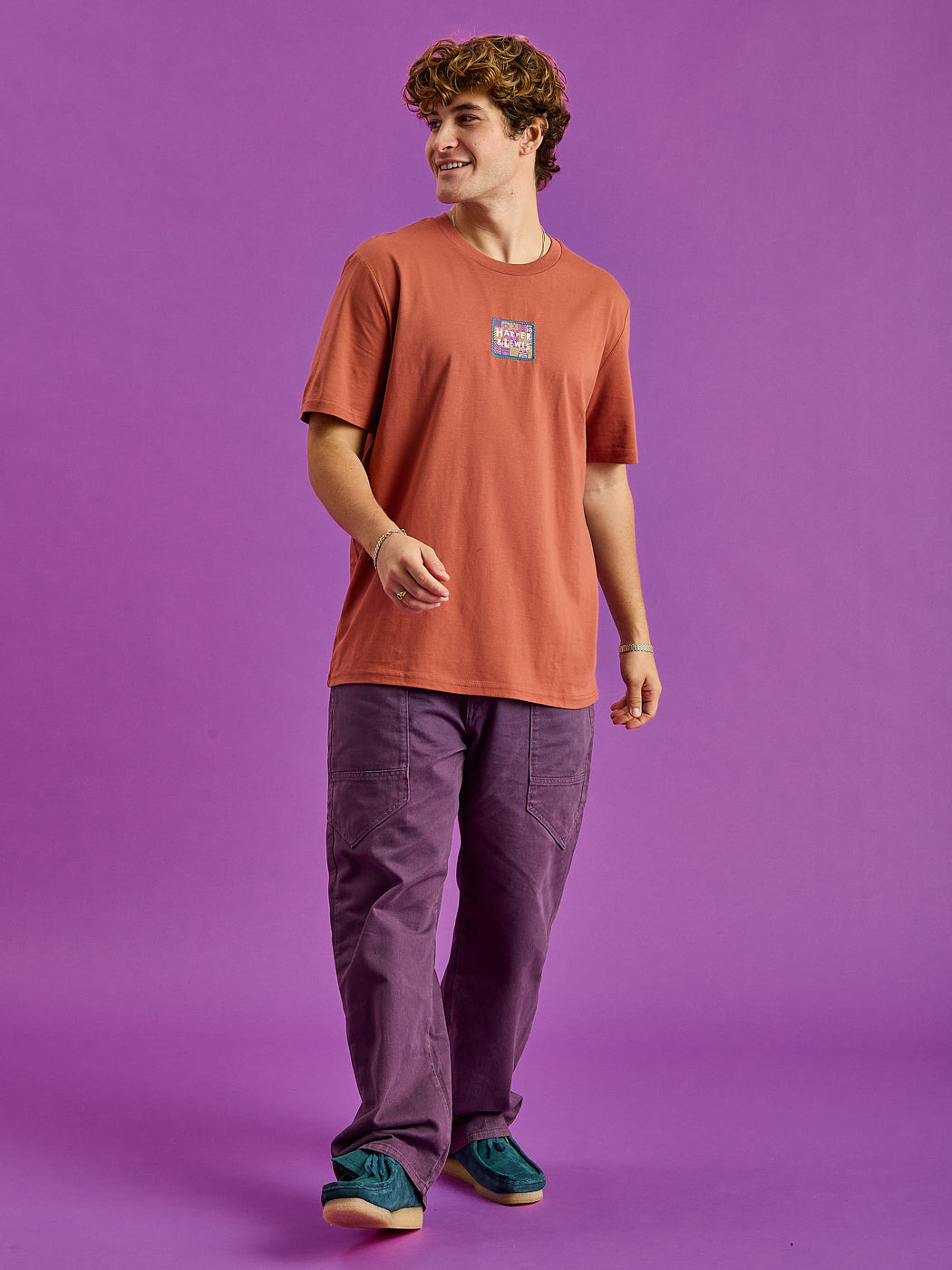 Male Model wears our Fable t-shirt featuring a branded badge