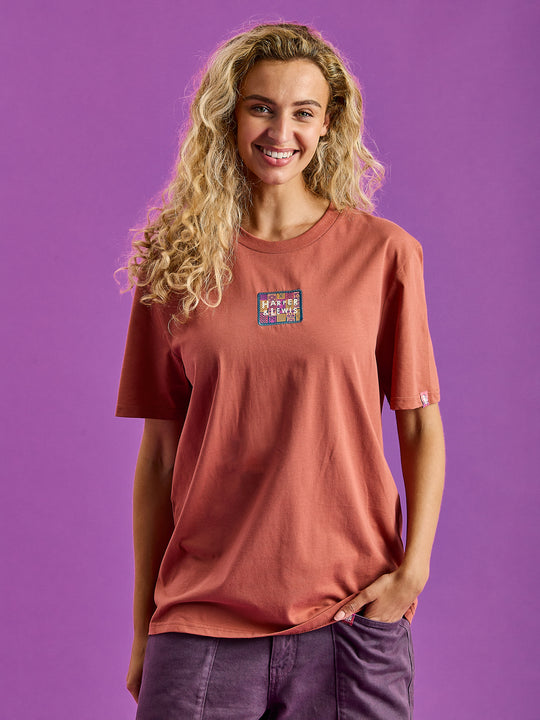 Female Model wears the Fable T-Shirt in a rust, which has a slight oversized fit