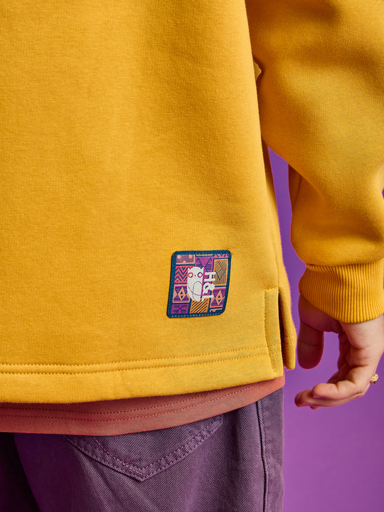 Detail shot of the branded aztec pattern badge on the back of the hoodie.