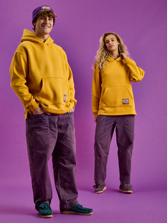 Both models wearing the Indiana Hoodie in Mustard, the ultimate blend of comfort and classic style.