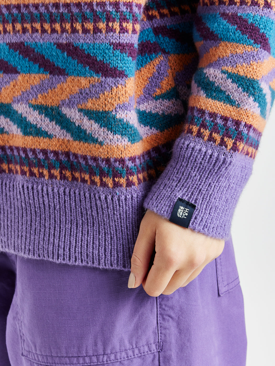 Branded Harper & Lewis tab on the purple contrasting ribbed cuff.