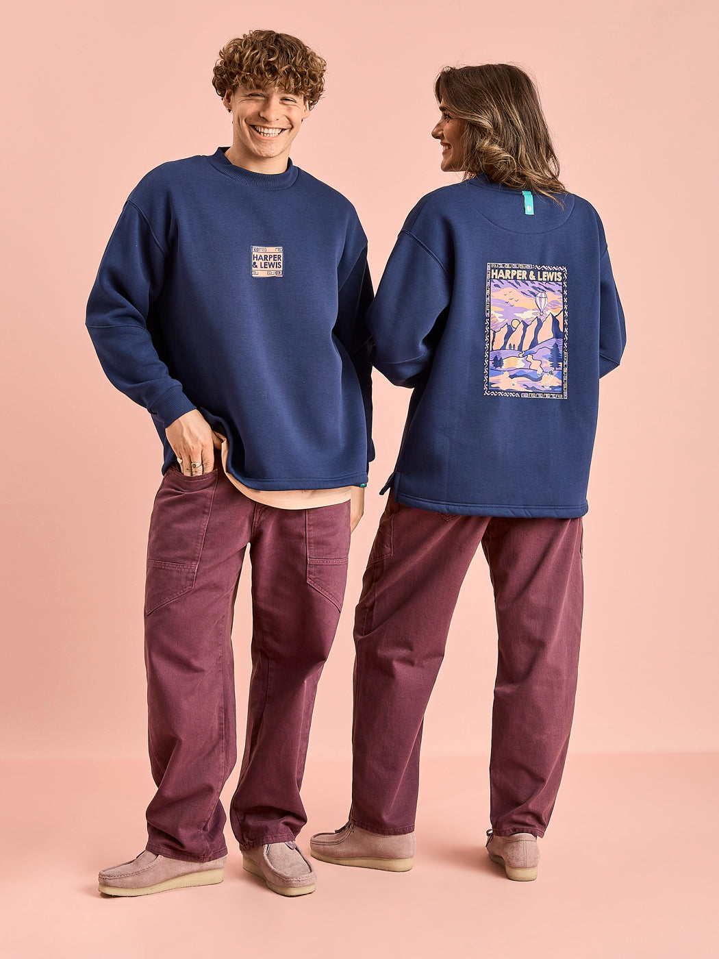 Both Model wearing the Atlas sweater in navy, this features branded prints on the front and back of the sweatshirt.