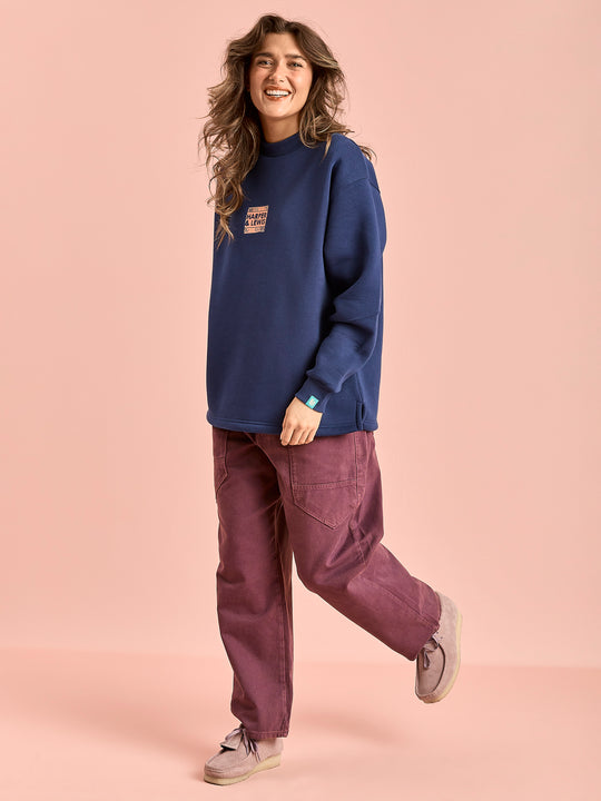 Female Model wears the oversized sweater which has a released hem for maximum comfort.